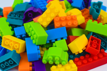 Lot of different color building blocks gathered together before a white background