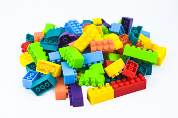 Portrait of different color building blocks gathered together before a white background