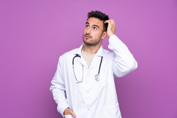 Young man wearing a doctor gown and having doubts