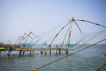 Chinese fishing nets are a tourist attraction in the Indian city of Kochi in Kerala. Large nets on the pier by the sea, fishermen and tourists