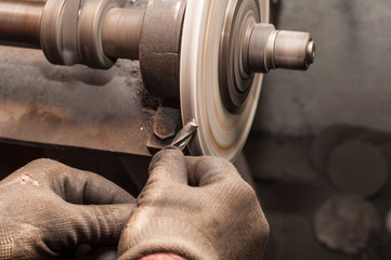 Worker sharpening drill with grindstone abrasive disc cutter machine