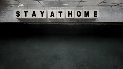 awareness concept - stay at home text on wooden blocks with vintage background