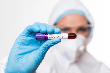Blood test tube in doctor hand, Mers-CoV Coronavirus test Positive label in hospital blood test tube for analysis.