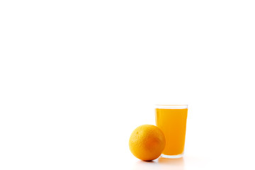 glass of orange juice and orange pieces