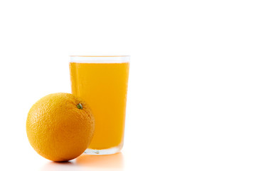 glass of orange juice and orange pieces