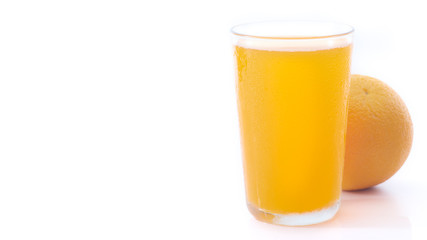glass of orange juice and orange pieces
