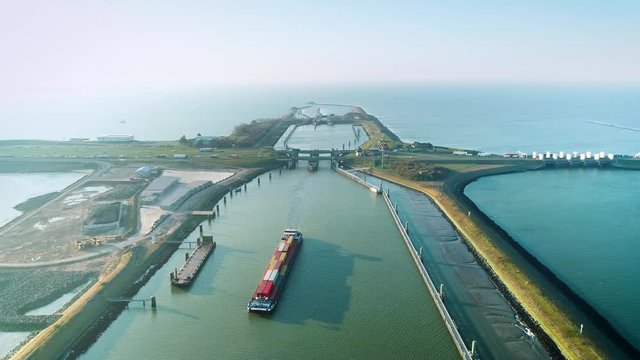 Enclosure Dam (Afsluitdijk): Large Cargo Ship Just Crossed the Dam, Traffic Jam Starting Up Again - Friesland, Netherlands / Holland &ndash; 4K Drone Footage