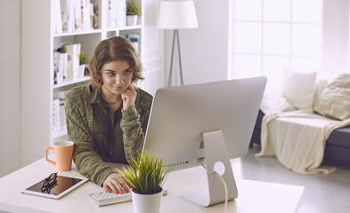 Young woman working with graphic tablet in office