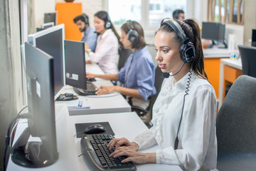 Female call center agent consulting client online while working in call center