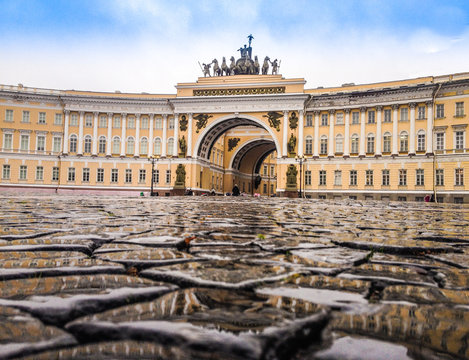 Paved the wet of rain stones at the Palace square in front of the arch of the General staff.