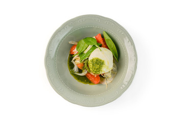 Salad mozzarella with vegetables in plate on white background. Top view