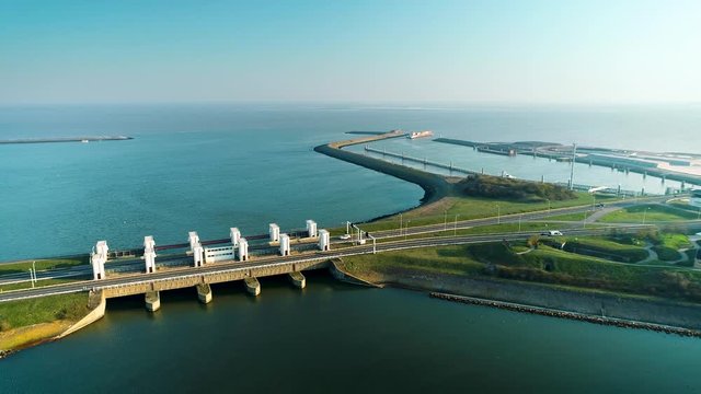 Enclosure Dam (Afsluitdijk): Cars Driving on the Long Road of the Dam, Large Cargo Ship in the Distance - Friesland, Netherlands / Holland &ndash; 4K Drone Footage