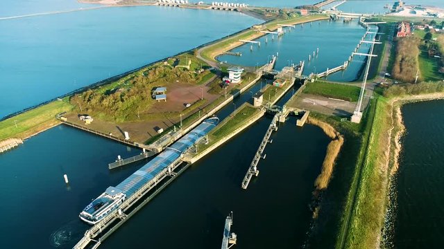 Enclosure Dam (Afsluitdijk): Large Cargo Ship Navigating Into the Very Narrow Sluice to Pass the Dam - Friesland, Netherlands / Holland &ndash; 4K Drone Footage