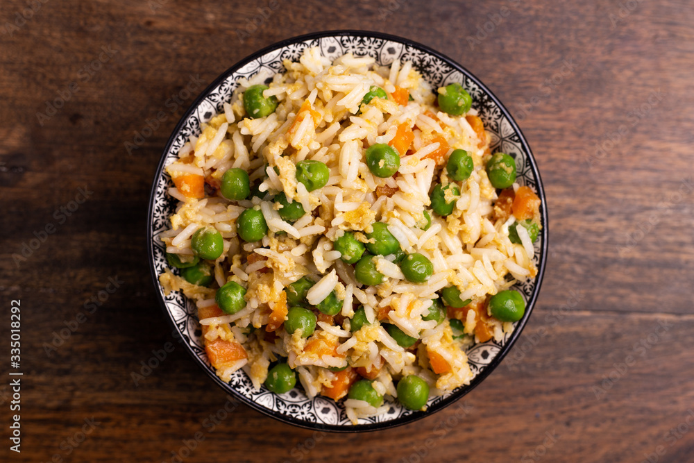 Wall mural Oriental cantonese rice. Basmati rice with green peas, eggs and carrots.