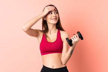 Young sport woman making weightlifting over isolated pink background has realized something and intending the solution