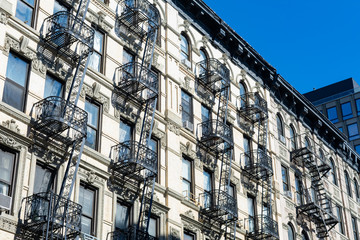 Row of Old White Stone Buildings with Fire Escapes on the Lower East Side of New York City