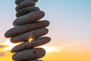 Beautiful sunny sunset over the sea, pebbles in the foreground. There is a place for text