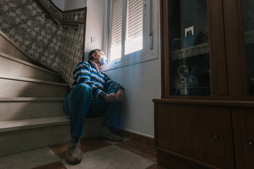 Selective focus of man with a mask confined in quarantine to prevent coronavirus spread to the...