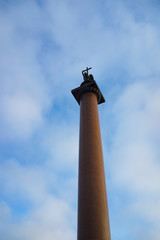 Saint Petersburg, Russia. Alexander Column with an angel on its top against cloudy blue sky