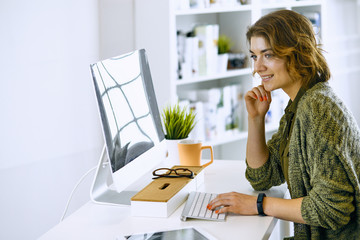 Young woman working with graphic tablet in office