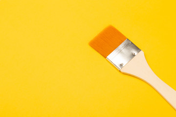 Paintbrush isolated on yellow background.