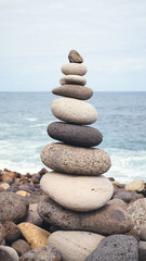 Fototapeta na wymiar Balanced stone stack on a beach, selective focus.
