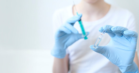 Person in white glove hold vaccine bottle with syringe. Injection pharmacy concept. Medical nurse therapy.