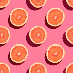 Seamless pattern of isolated on pink cutter grapefruit.