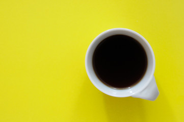 white coffee mug with yellow background top view