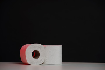 Toilet paper roll on black white background. Cheap toilet wipes for hygiene purposes. Soft hygienic paper.