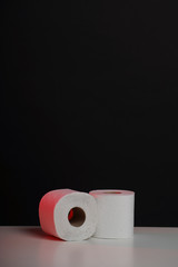 Toilet paper roll on black white background. Cheap toilet wipes for hygiene purposes. Soft hygienic paper.