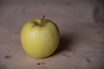 Green apple on a wooden base. Healthy food from Serbia.
