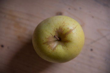 Green apple on a wooden base. Healthy food from Serbia.