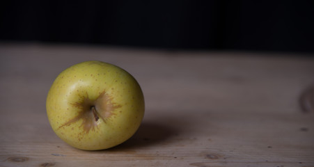 Green apple on a wooden base. Healthy food from Serbia.