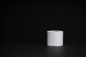 Toilet paper rolls on a black background. Cheap toilet wipes for hygiene purposes.