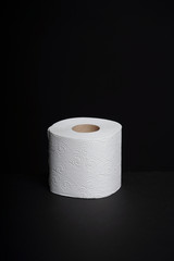 Toilet paper rolls on a black background. Cheap toilet wipes for hygiene purposes.