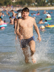 A man runs on the water on the seashore