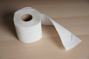 Soft hygienic toilet paper on wood background