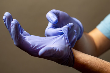 Step of hand throwing away blue disposable gloves medical, Isolated on white background. Infection...