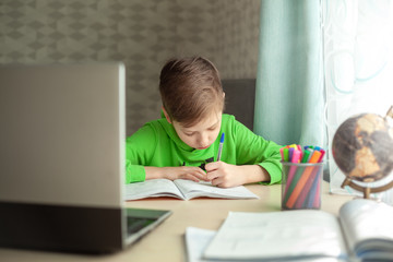 Fototapeta na wymiar Distance learning Child writting homework with digital tablet. Concept online education.