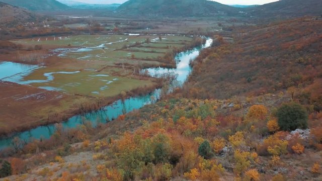 Reflection of Clouds in the Blue Autumn River. Swampy Landscape Matica River Plane. Aerial Footage of a Swampy River and Green Flooded Fields From a Bird's Eye View. Rijeka Matica kod Luznice Komani