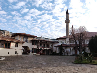 several ancient houses with tiled roofs and a mosque