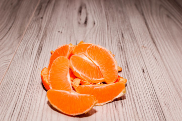 Slices of orange placed on a wooden table