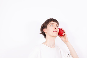 The young handsome man holds paprika like a smartphone. This situation looks like a normal phone talk, but this is only a symbolic picture. It can be called quasi phone talk.