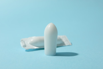 Anal or vaginal candles on blue background, close up