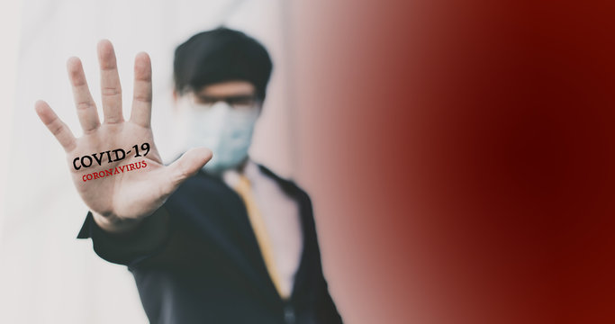 Young Asian Business Man In Protective Sterile Medical Mask On Face Looking At Camera Showing Gesture Stop, Stop No Sign. People In Masks Outbreak Of Corona Virus (2019-nCoV)