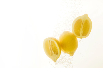 Lemons in water splash. Tasty and healthy summer food on white background.