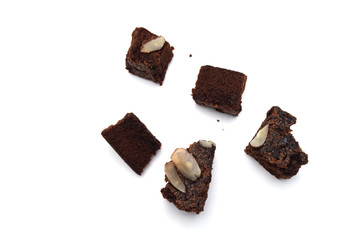 Chocolate brownie with sliced almond nuts toppings crumbs isolated on white background.