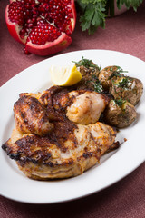 Grilled whole chicken with potatoes