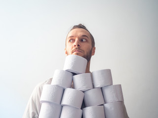 Young Blond Hair Caucasian Male Hoarding Toilet Paper for Covid-19 Looking at the Camera © Alexandre